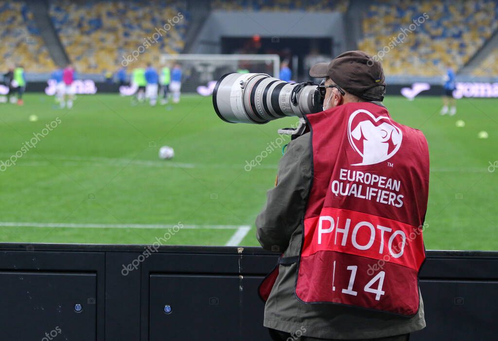 KYIV, UKRAINE - MARCH 28, 2021: Photographer at work seen during the FIFA World Cup 2022 Qualifying round game Ukraine v Finland at NSK Olimpiyskiy stadium in Kyiv, Ukraine