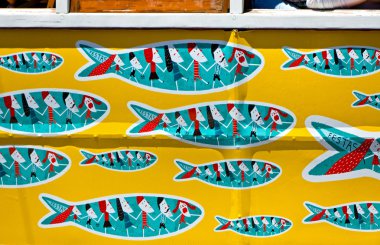 Details of traditional Lisbon yellow tram decorated with sardine clipart