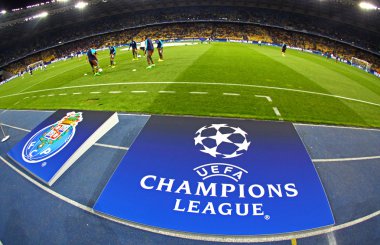 Board with UEFA Champions League Logo on the ground