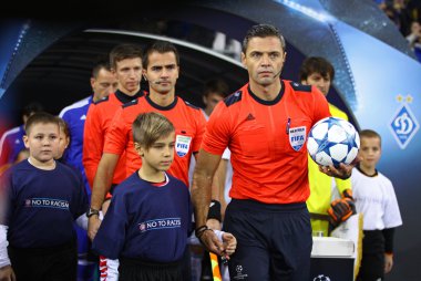Referee and his assistants go to the pitch