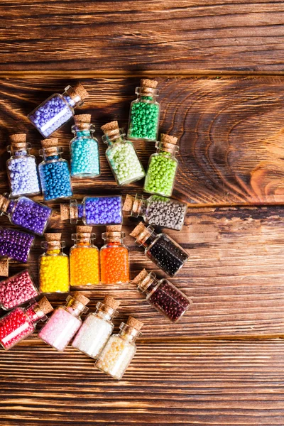 Colorful beads in the bottles — Stock Photo, Image