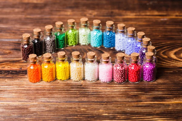 Colorful beads in the bottles — Stock Photo, Image