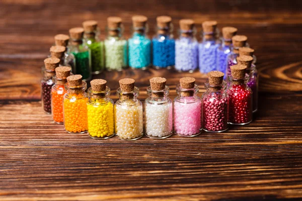 Colorful beads in the bottles — Stock Photo, Image