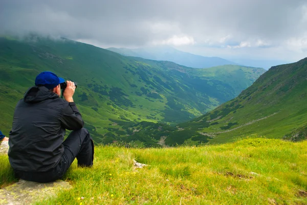 Man looks on the mountains — Stock Photo, Image