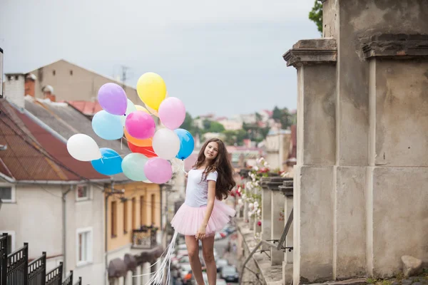 Menina com balões de látex coloridos — Fotografia de Stock