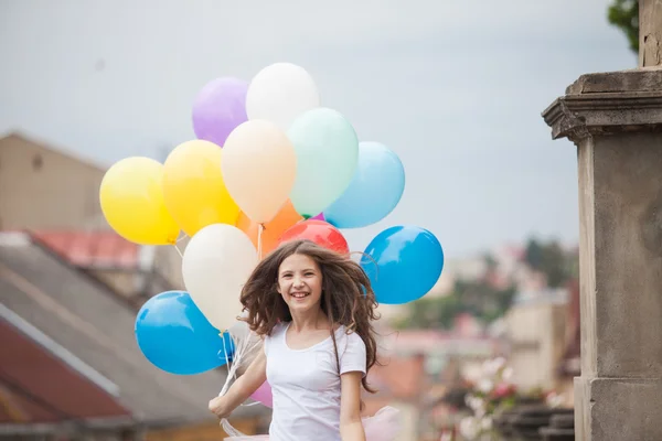 Girl with colorful latex balloons — Stock Photo, Image