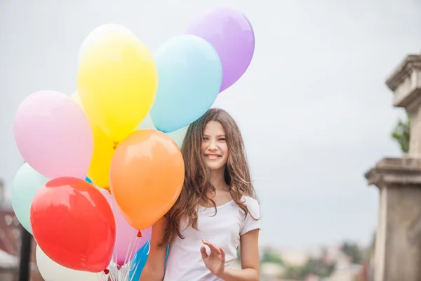 Girl with colorful latex balloons — Stock Photo, Image