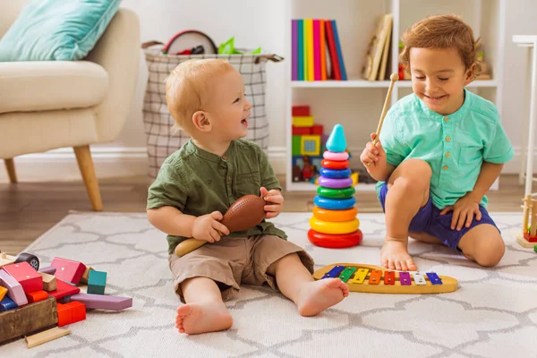 Os meninos brincam com brinquedos musicais no jardim de infância — Fotografia de Stock