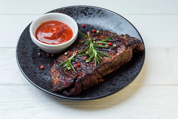 One huge piece of grilled fillet with red sauce — Stock Photo, Image