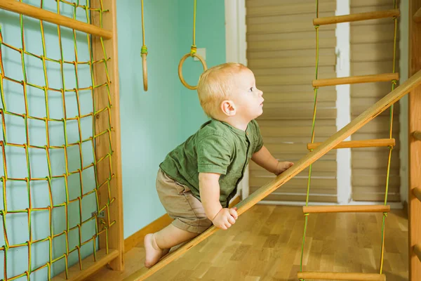 Comprehensive physical development in the gym for a toddler boy — Stock Photo, Image