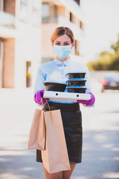 Delivery women in medical mask and rubber gloves