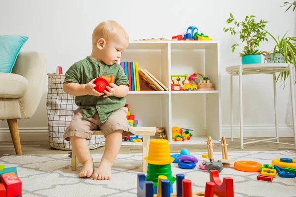 Thoughtful boy looking for remaining parts of toy — Fotografia de Stock