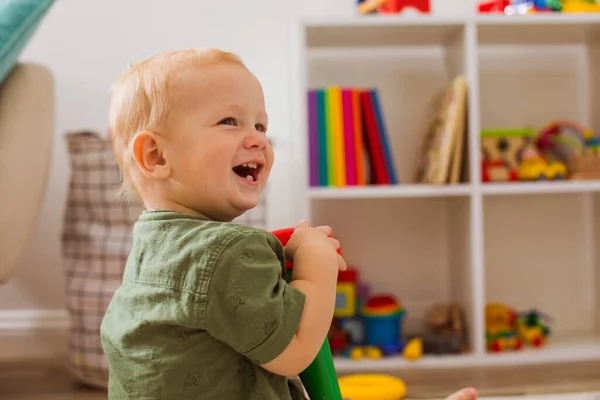 The toddler boy has fun in the playroom — Fotografia de Stock