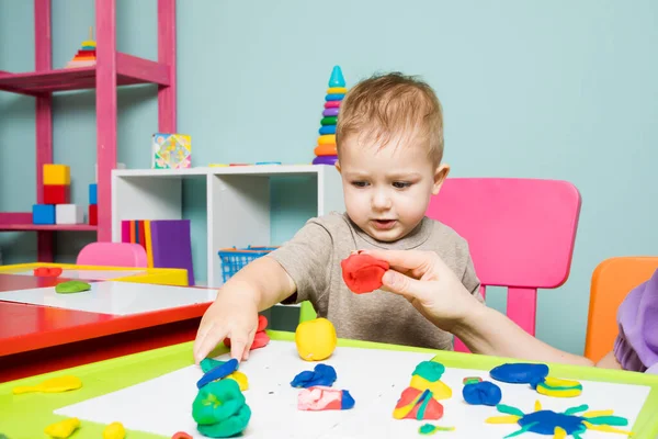 The baby boy develops creativity in the childrens center — Photo