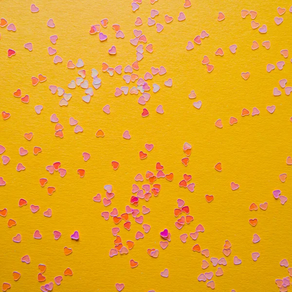 Scattering pink small hearts on a pink background — Stock Photo, Image