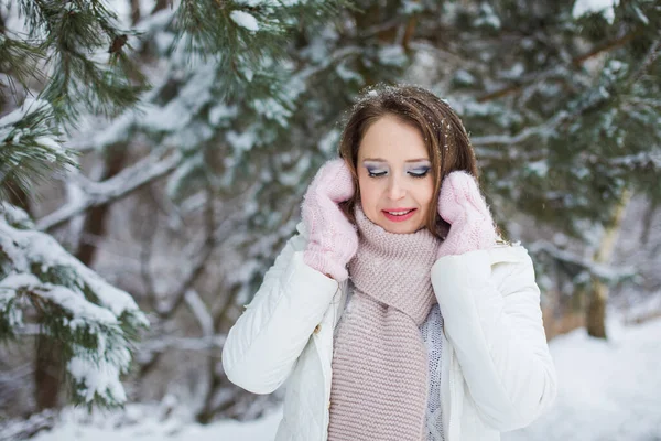 Woman look down and miles under the snow covered tree