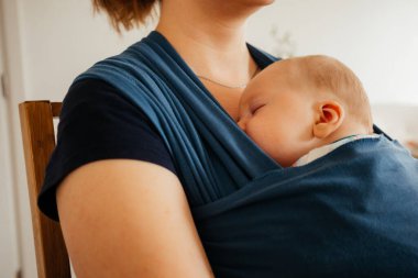 Mother feeling tired after hours of comforting her baby clipart