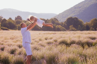 Babası kızını beyaz elbiseler içinde büküyor.