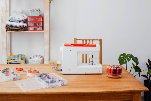 Modern sewing machine with variety of threads in box