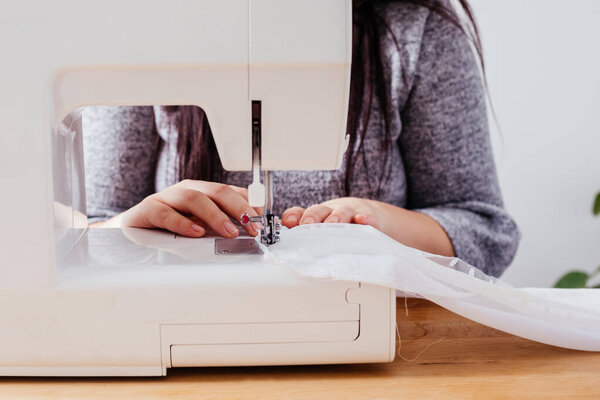 Wedding dressmaker altering white vintage wedding dress