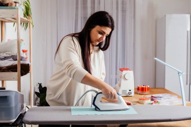 Deseni kesip dikmeden önce tekstil ütüleme işlemi