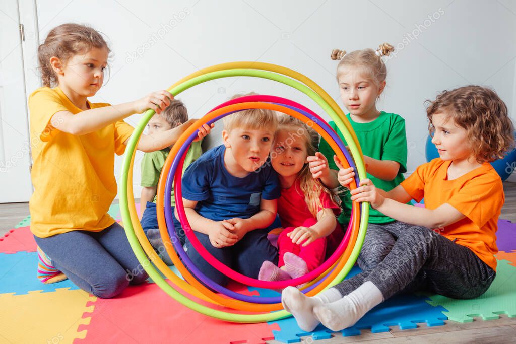 Portrait of smiling children with hula hoops