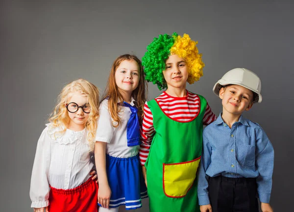 Los niños alegres en diferentes profesiones trajes — Foto de Stock