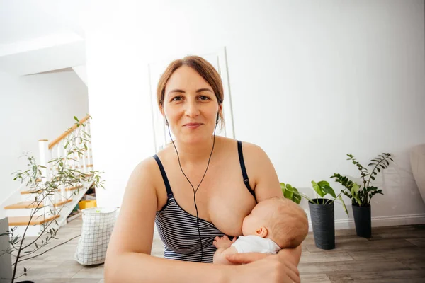 Портрет матери, кормящей грудью во время онлайн-встречи — стоковое фото