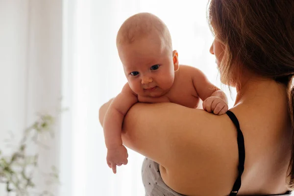 Μητέρα με γυμνό νεογέννητο στο φωτεινό λευκό φόντο — Φωτογραφία Αρχείου