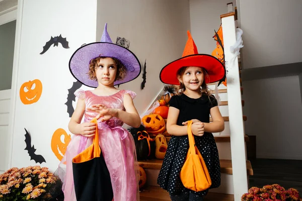 Little girls witches waiting for halloween treats — Stock Photo, Image