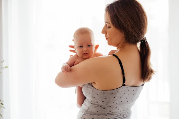 Μητέρα με γυμνό νεογέννητο στο φωτεινό λευκό φόντο — Φωτογραφία Αρχείου