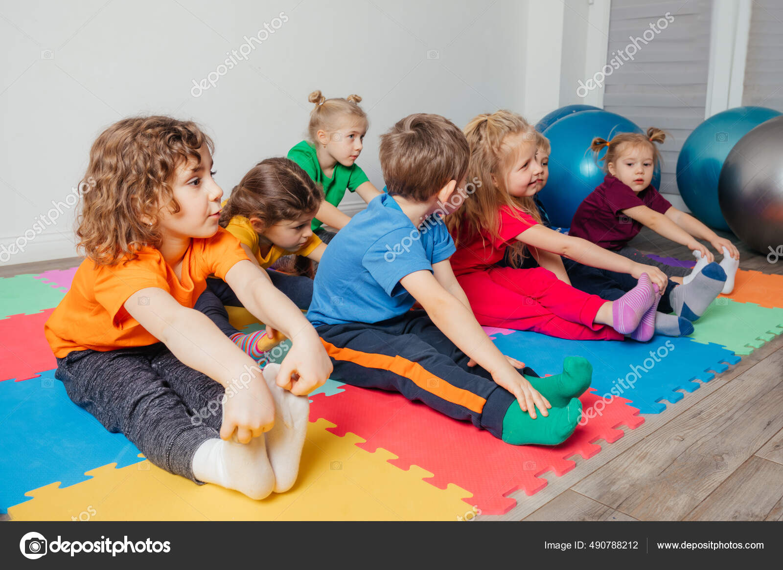 Children exercising while physical education lesson at preschool Stock Photo oksixx 490788212