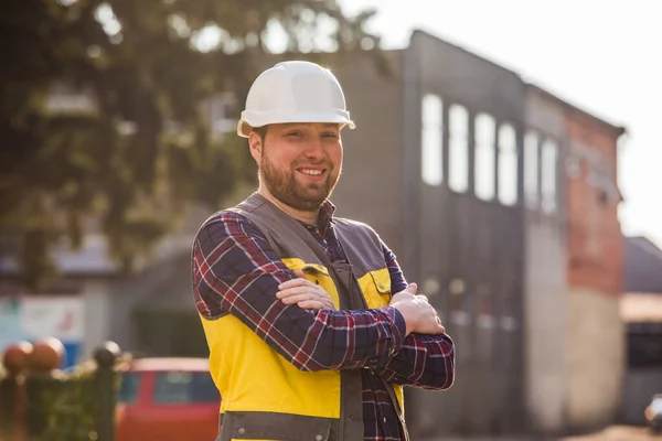 Factory worker posing in front of workshop