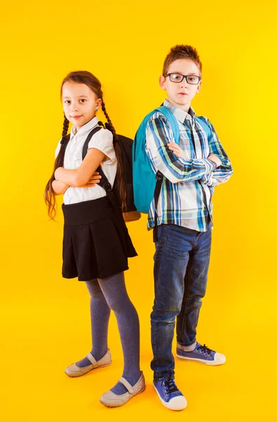 De kleine schoolkinderen kijken elkaar aan. — Stockfoto