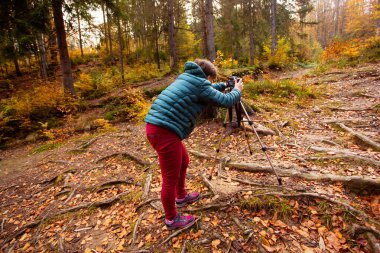 Seyahat fotoğrafçısı fotoğraf çekmek için kamera ve tripod kullanır.