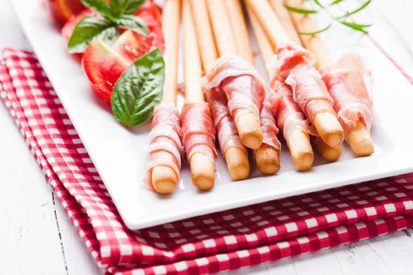 Grissini with prosciutto — Stock Photo, Image