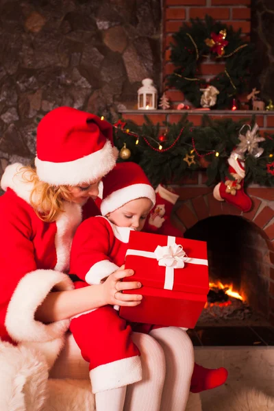 Madre e hijo cerca de la chimenea de Navidad — Foto de Stock