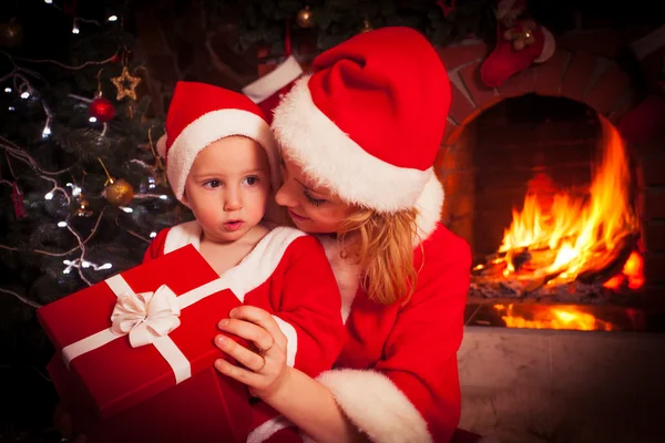 Mother and son near Christmas fireplace — Stock Photo, Image