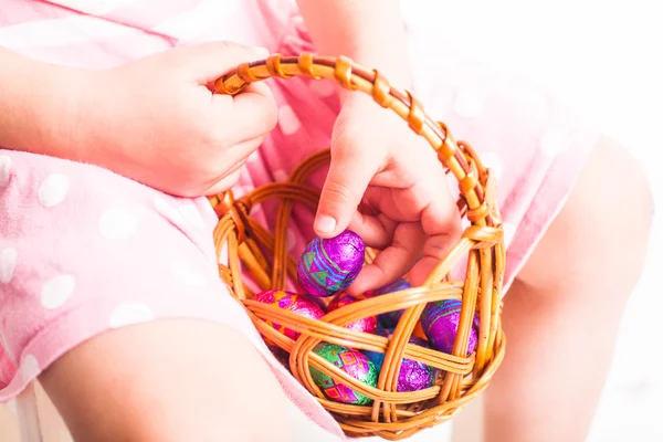 Girl eats a chocolate eggs — Stock Photo, Image