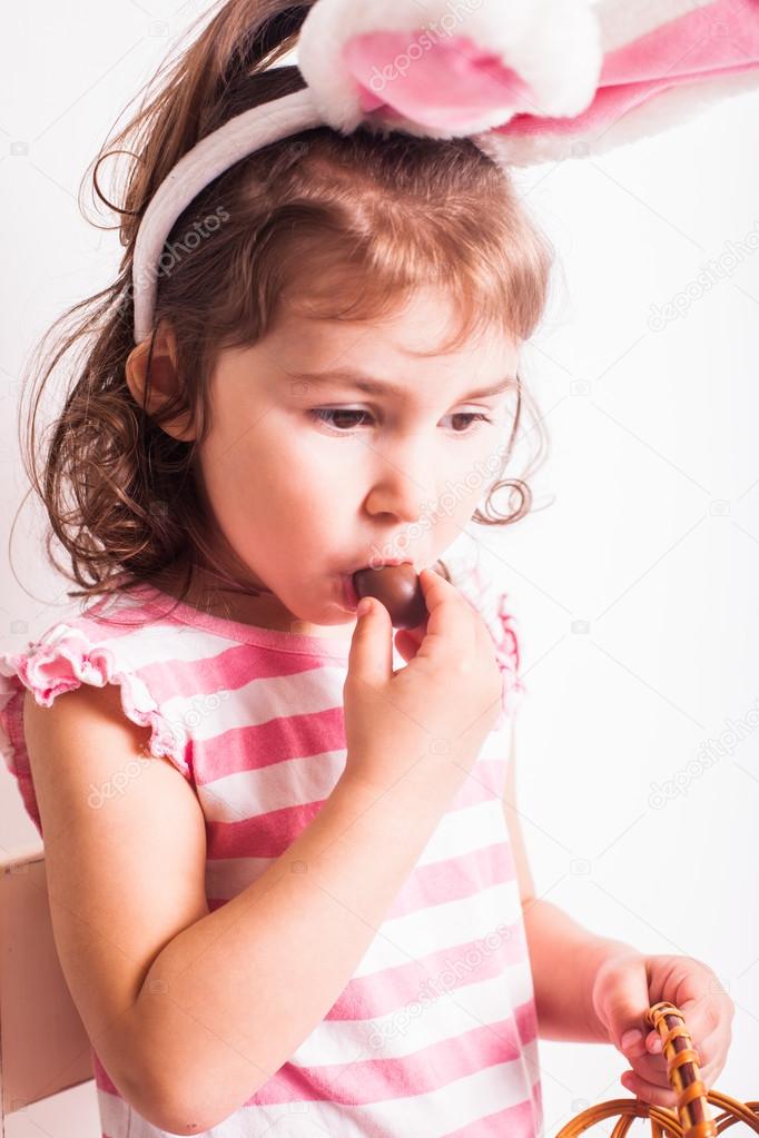 Girl eats a chocolate eggs