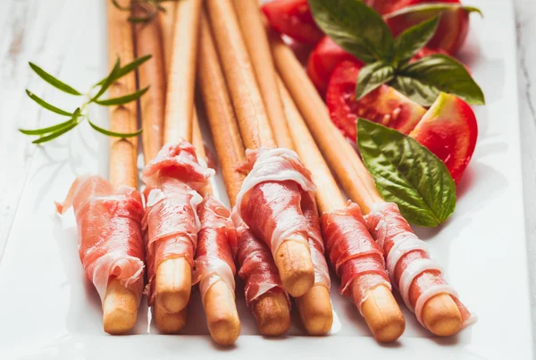 Grissini with prosciutto — Stock Photo, Image