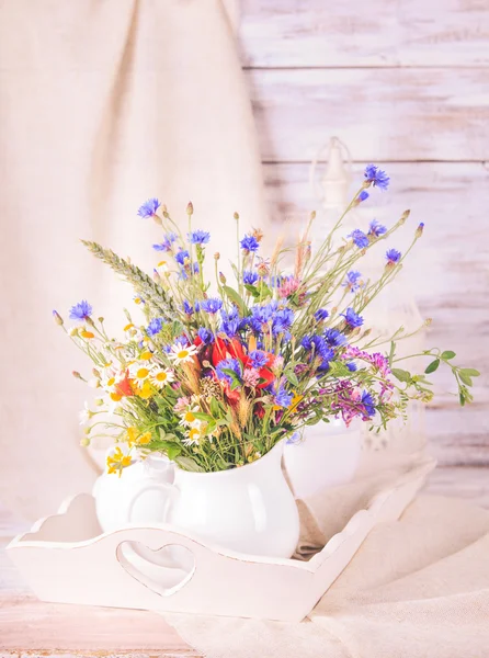 Wildflowers in bottles — Stock Photo, Image