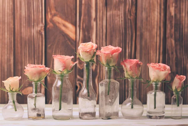 Roses in bottles — Stock Photo, Image