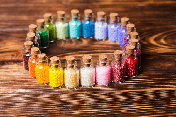 Colorful beads in the bottles — Stock Photo, Image