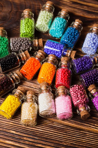 Colorful beads in the bottles — Stock Photo, Image