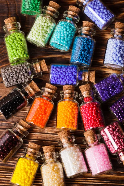 Colorful beads in the bottles — Stock Photo, Image