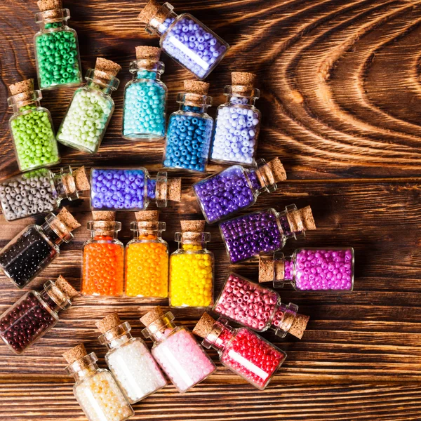 Colorful beads in the bottles — Stock Photo, Image