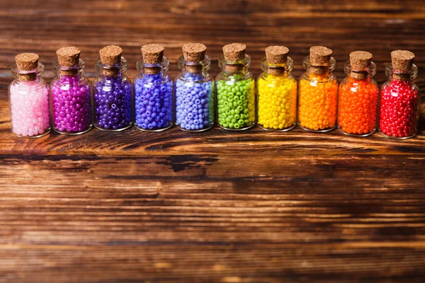 Colorful beads in the bottles — Stock Photo, Image