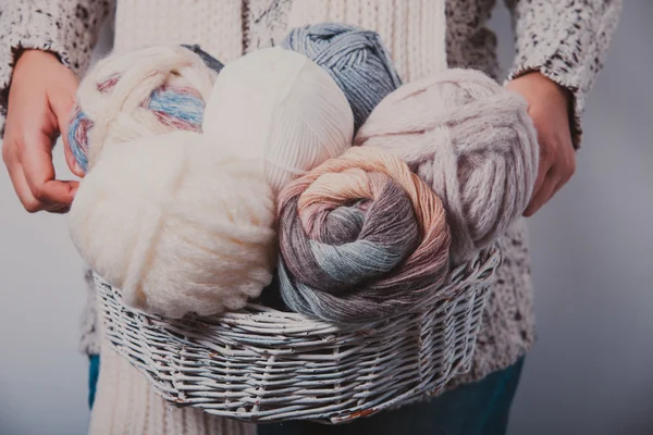 Woman with basket of balls woolen yarn — Stock Photo, Image