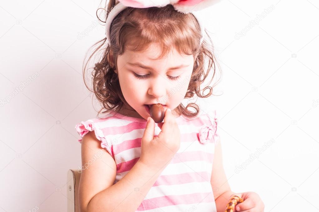 Girl eats a chocolate eggs